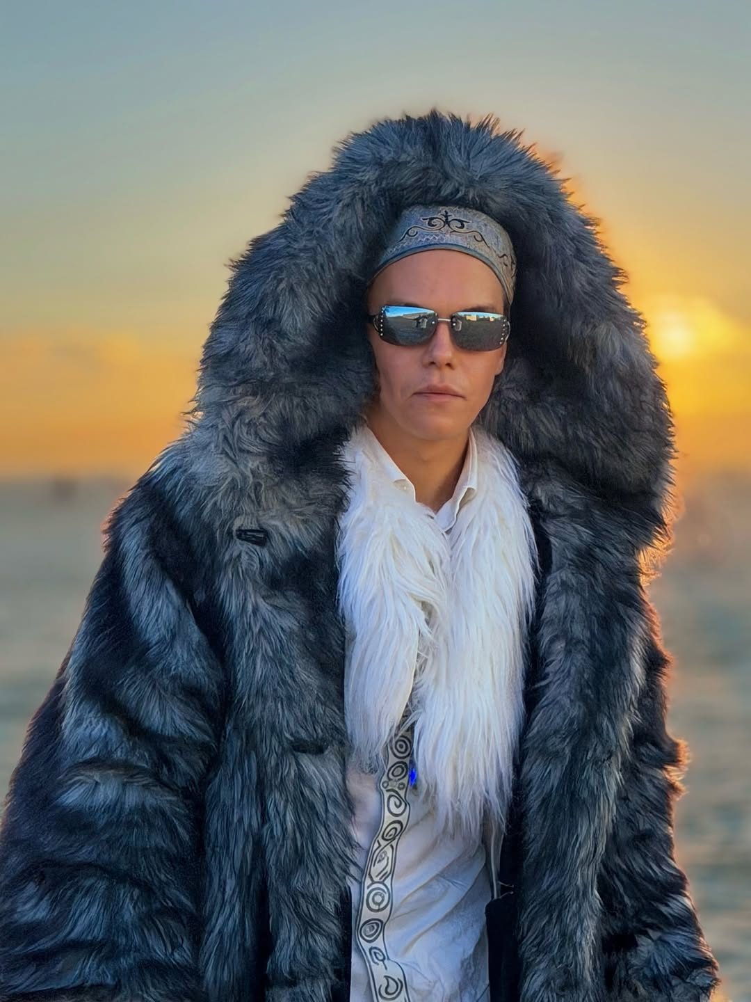 NAŸL in a fur coat at sunset on the playa